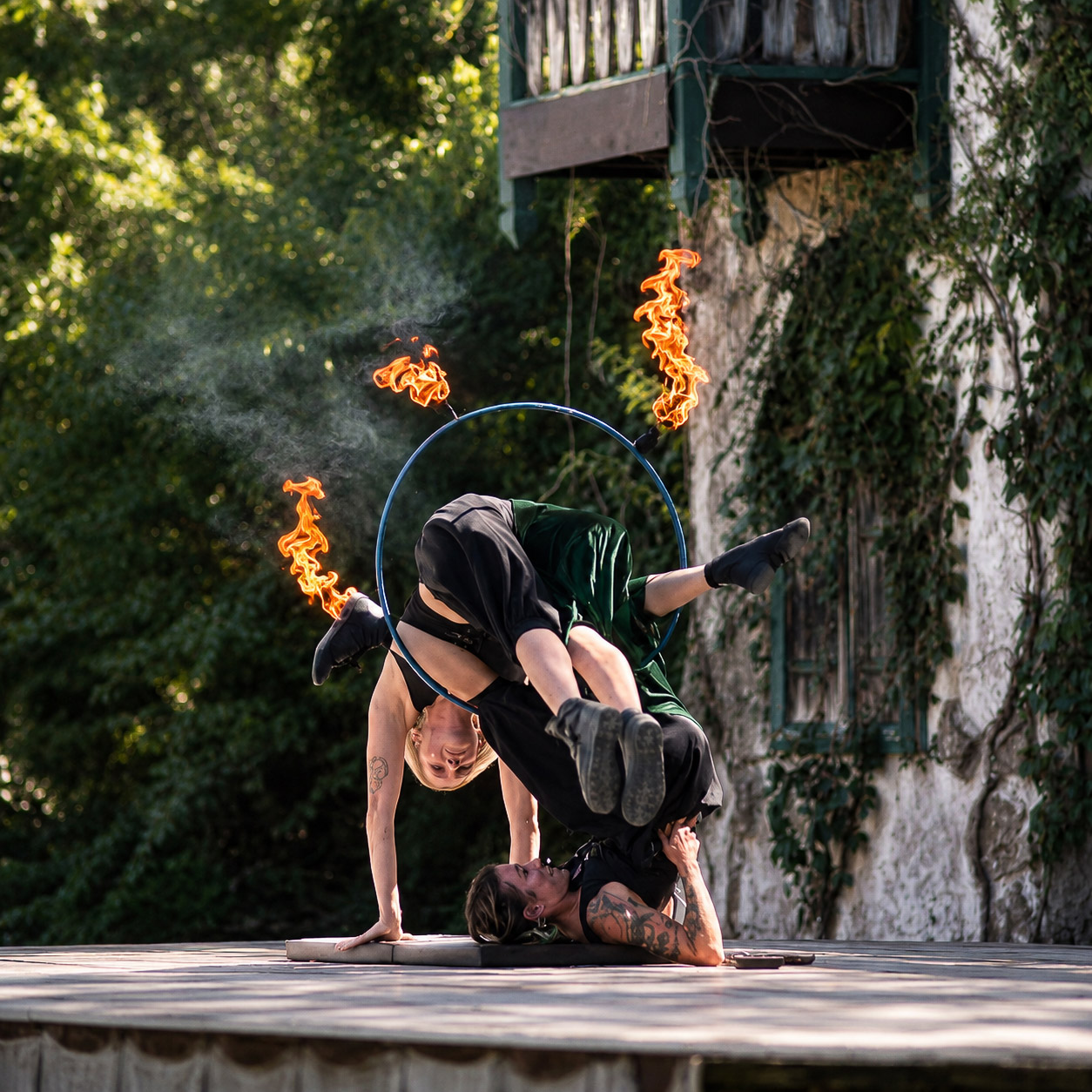 Fire acrobatics, one performer balanced overhead