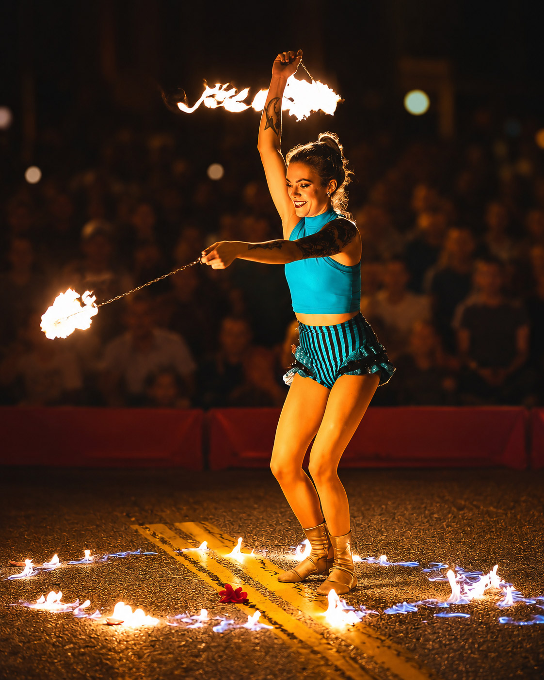 Fire performer at night in front of a packed crowd