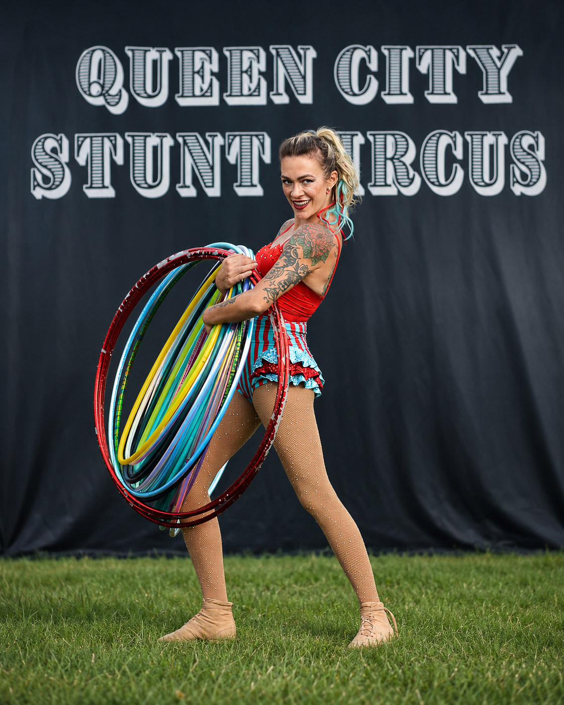 Performer with a rainbow LED hoop lighting up the dark